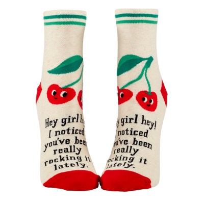 Blue Q ankle socks featuring the message "Hey Girl Hey! I Noticed You’ve Been Really Rocking It Lately," designed to spread positivity and celebrate hard work.